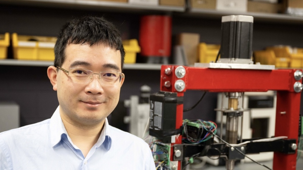 Xuan Song poses for a photo in his lab